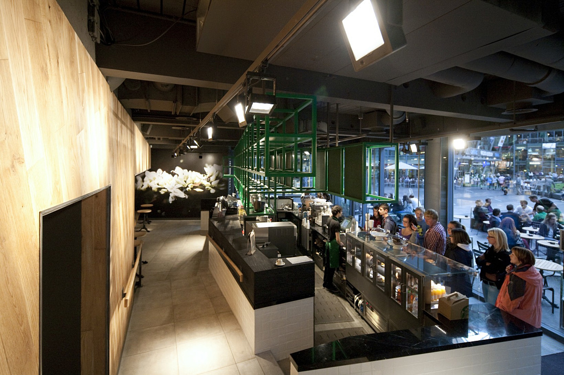 Interior of Starbucks Coffee House in Berlin featuring ERCO LED lighting for an inviting ambiance.