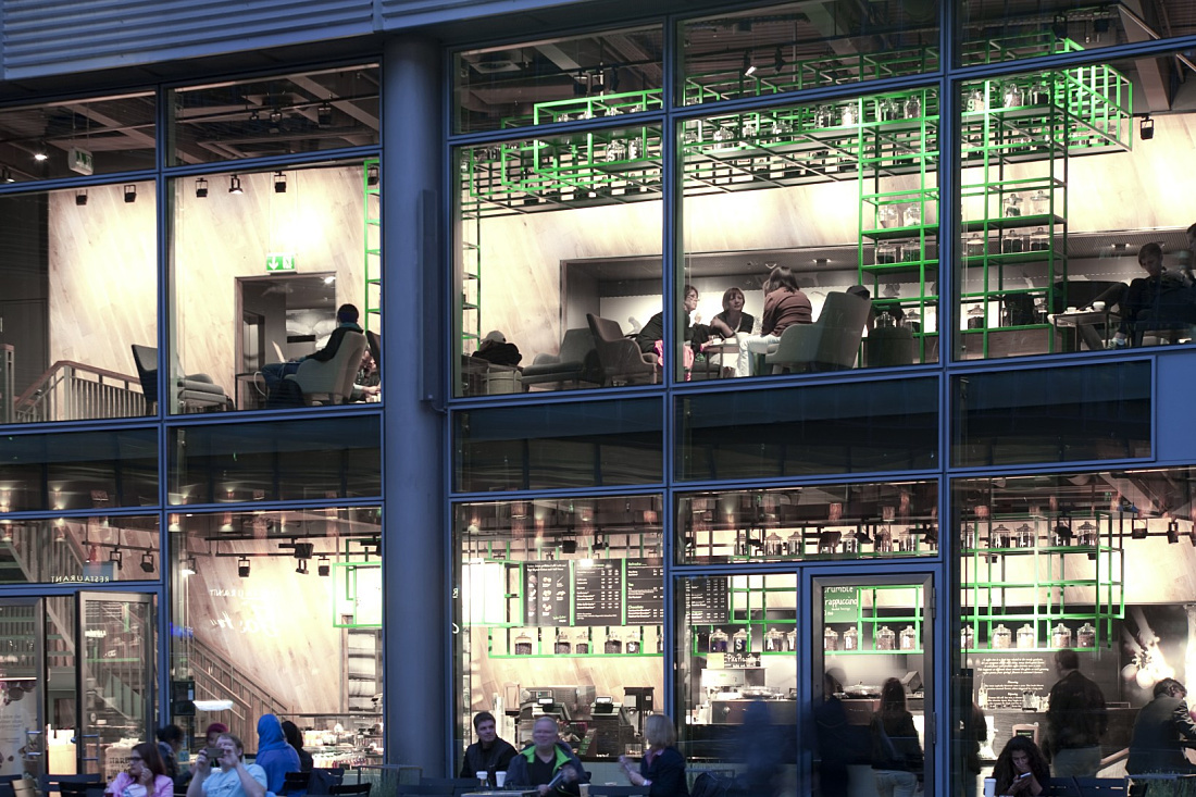Starbucks Coffee House in Berlin, showcasing its inviting lighting and interior.