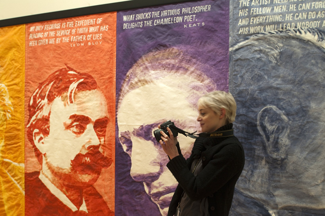 Woman photographs art at the Stedelijk Museum, Amsterdam, illuminated by ERCO LEDs.