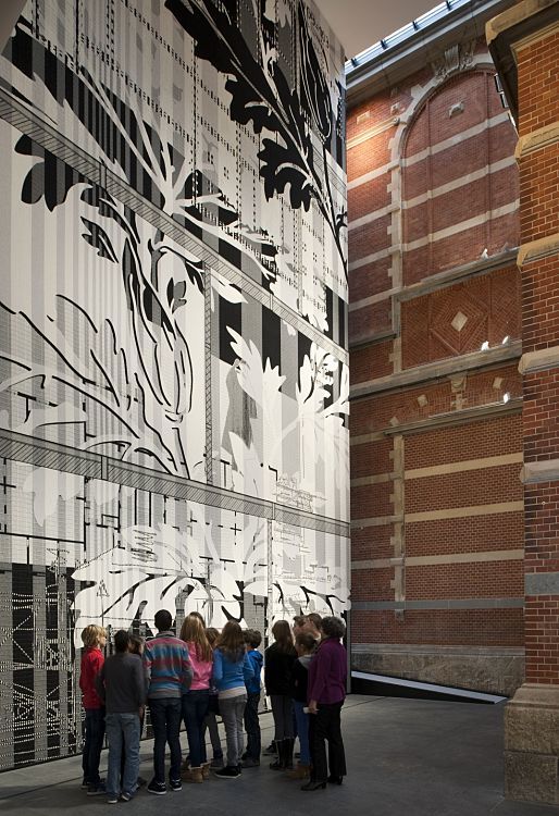 Visitors admire art at the Stedelijk Museum, illuminated by ERCO LED lighting.