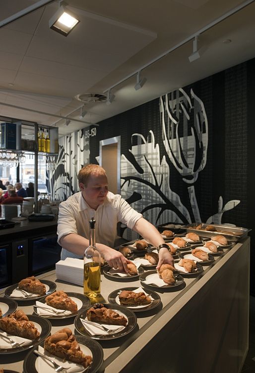 A man prepares food under ERCO lighting at the Stedelijk Museum, Amsterdam.