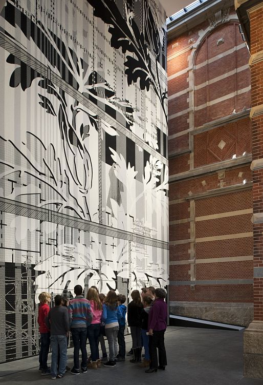 Visitors admire art at the Stedelijk Museum, illuminated by ERCO LED lighting.