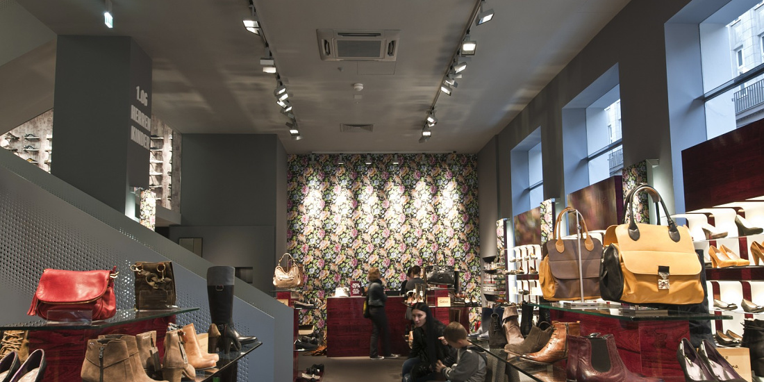 Interior of Stiefelkönig shoe shop illuminated by ERCO Light Board LED spotlights for accent lighting.