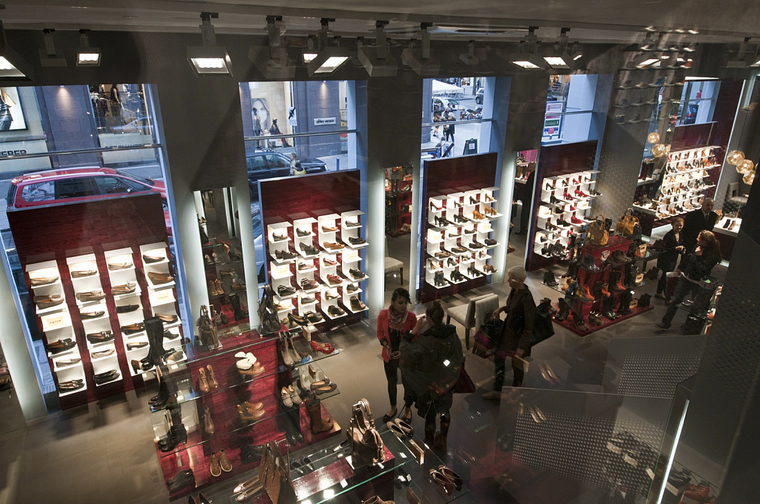 Interior of Stiefelkönig shoe shop featuring ERCO Light Board LED spotlights for bright and appealing product presentation.