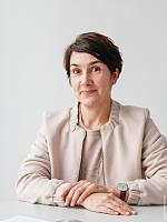 Portrait of a woman, possibly an ERCO employee, in the context of Swatch headquarters lighting.