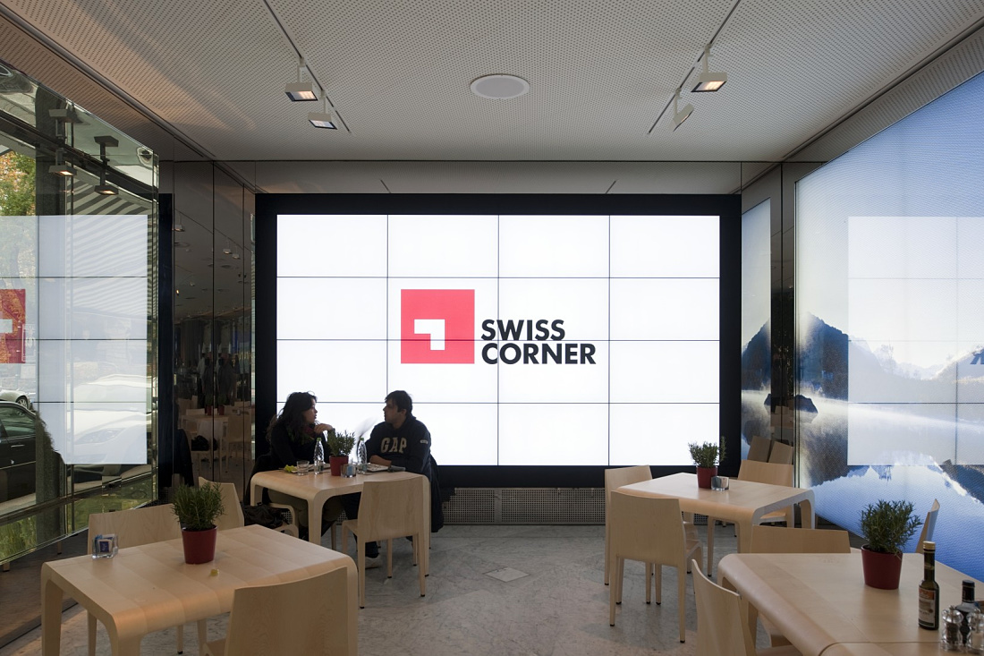 Swiss Corner Bar in Milan, featuring modern LED lighting with ERCO Light Board spotlights.