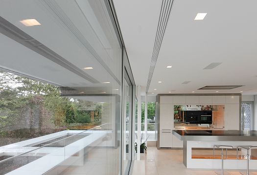 Modern Villa Linari kitchen featuring ERCO LED lighting and garden view.