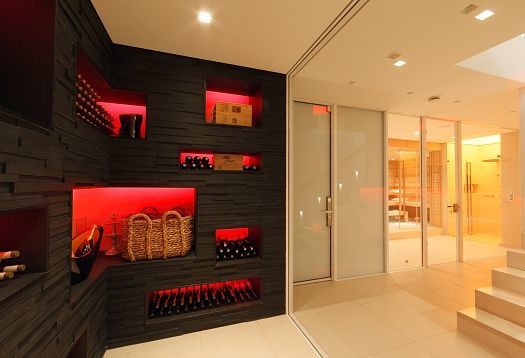 Wine rack with LED lighting in Villa Linari, Hamburg. Synesthetic architecture with multi-sensory room experience.