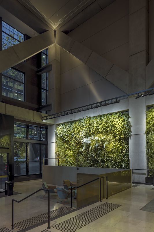ERCO Light Board spotlights illuminate a green wall in the 565 Bourke Street office building foyer.