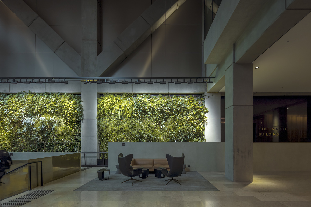 Green wall in 565 Bourke Street foyer, illuminated by ERCO Light Board spotlights.