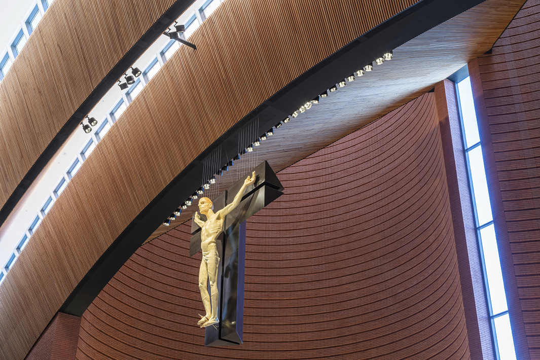 Interior of Namyang Rosary Hill church featuring ERCO lighting and a crucifix.