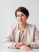 Portrait of a woman in a blazer, possibly an ERCO employee or lighting designer.