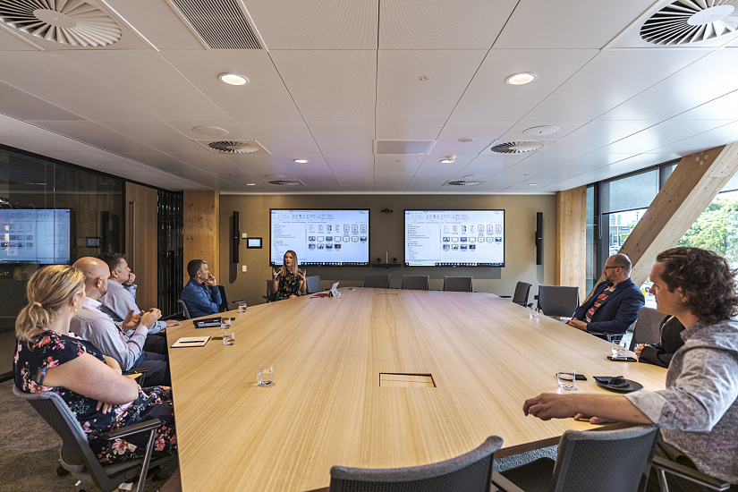 Conference room in timber building featuring ERCO LED lighting for efficient office illumination.