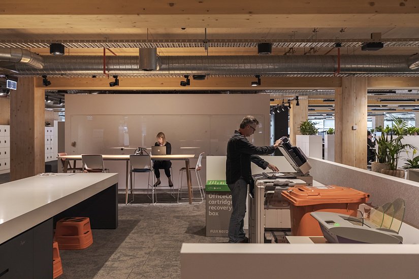 Office workspace with ERCO LED lighting in a modern timber building, creating a comfortable work atmosphere.