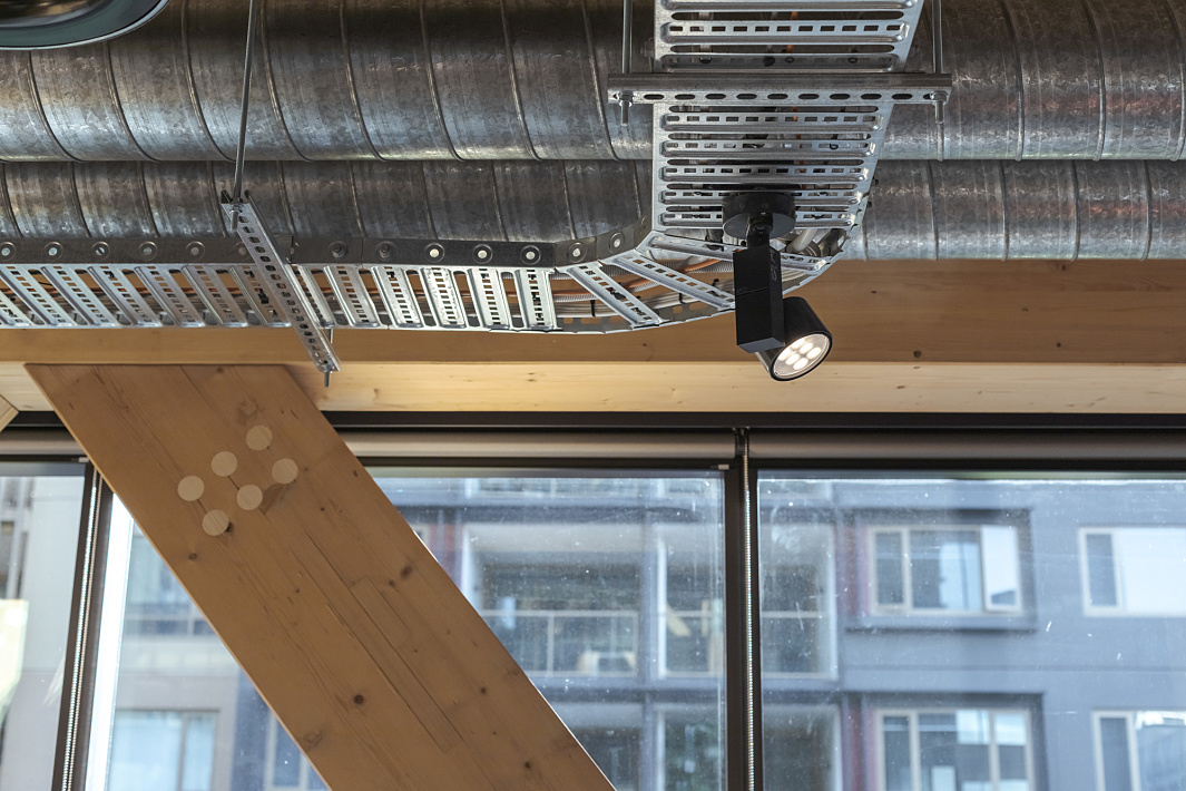 ERCO Optec spotlight on the timber building ceiling, providing flexible office lighting.