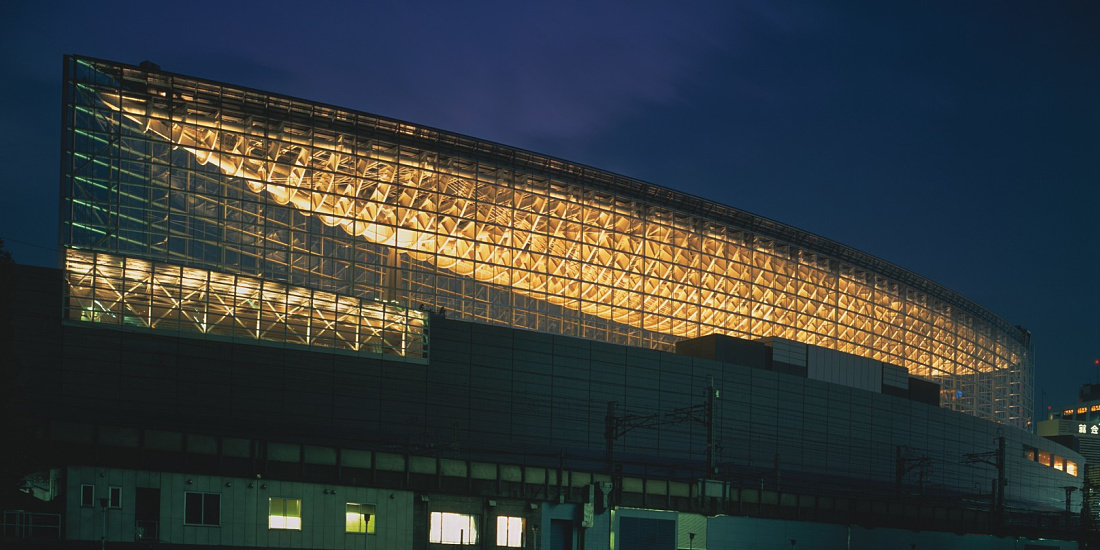 The illuminated Tokyo International Forum showcases its striking steel structure at night.