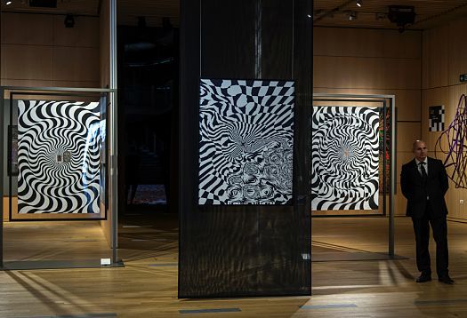 Art exhibit in UniCredit Pavilion, Milan, featuring abstract black and white paintings and ERCO lighting.