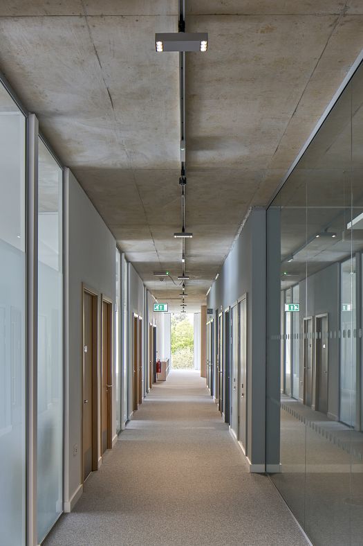University of Bath school hallway featuring ERCO Atrium surface-mounted luminaires for sustainable lighting.