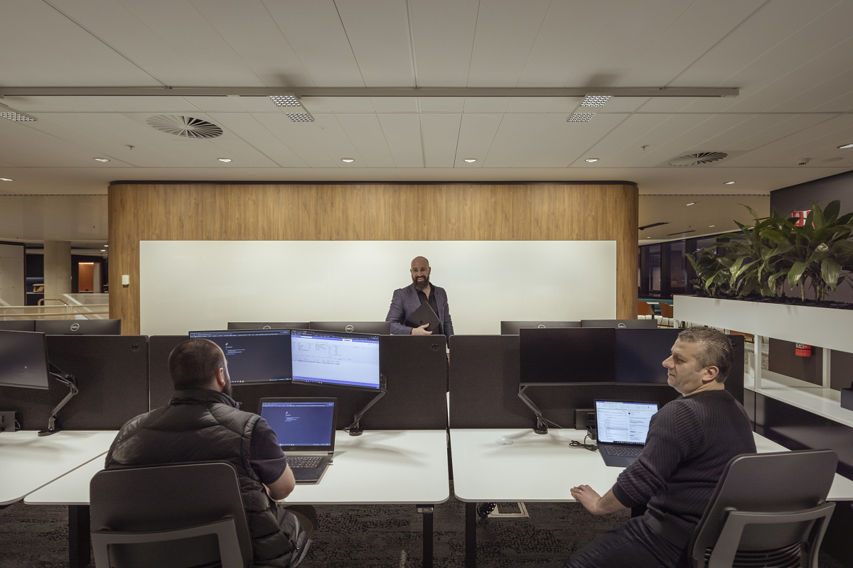ERCO Jilly downlights illuminate a modern VicRoads office space for flexible work.