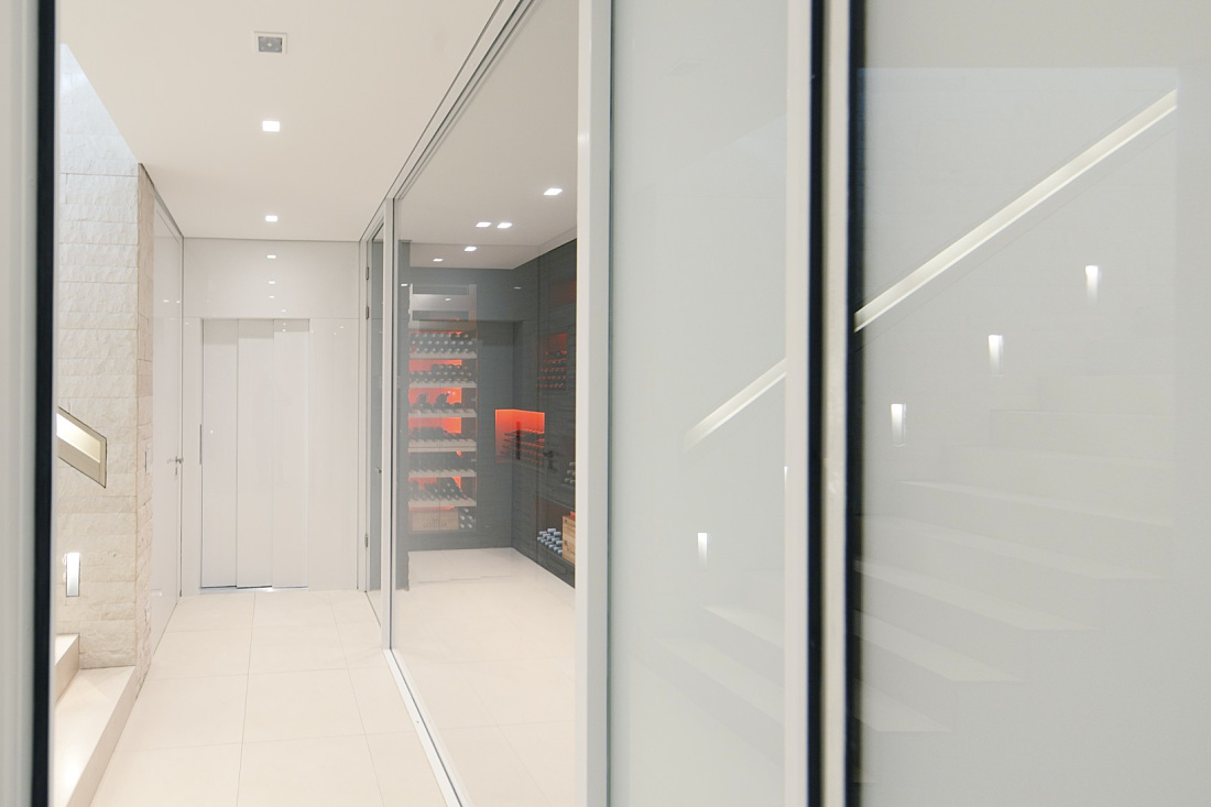 Villa Linari interior featuring Quintessence downlights and RGBW lit wine storage.