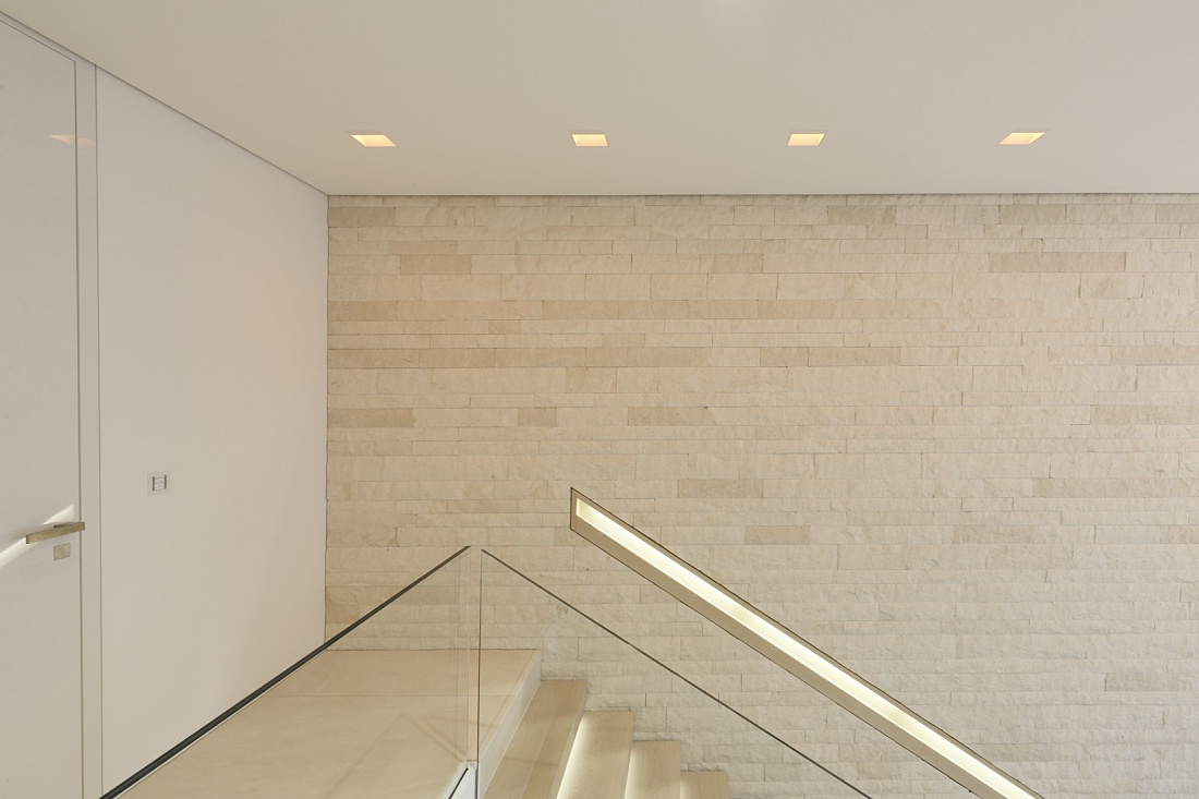 Villa Linari staircase featuring Quintessence downlights for high-quality lighting.