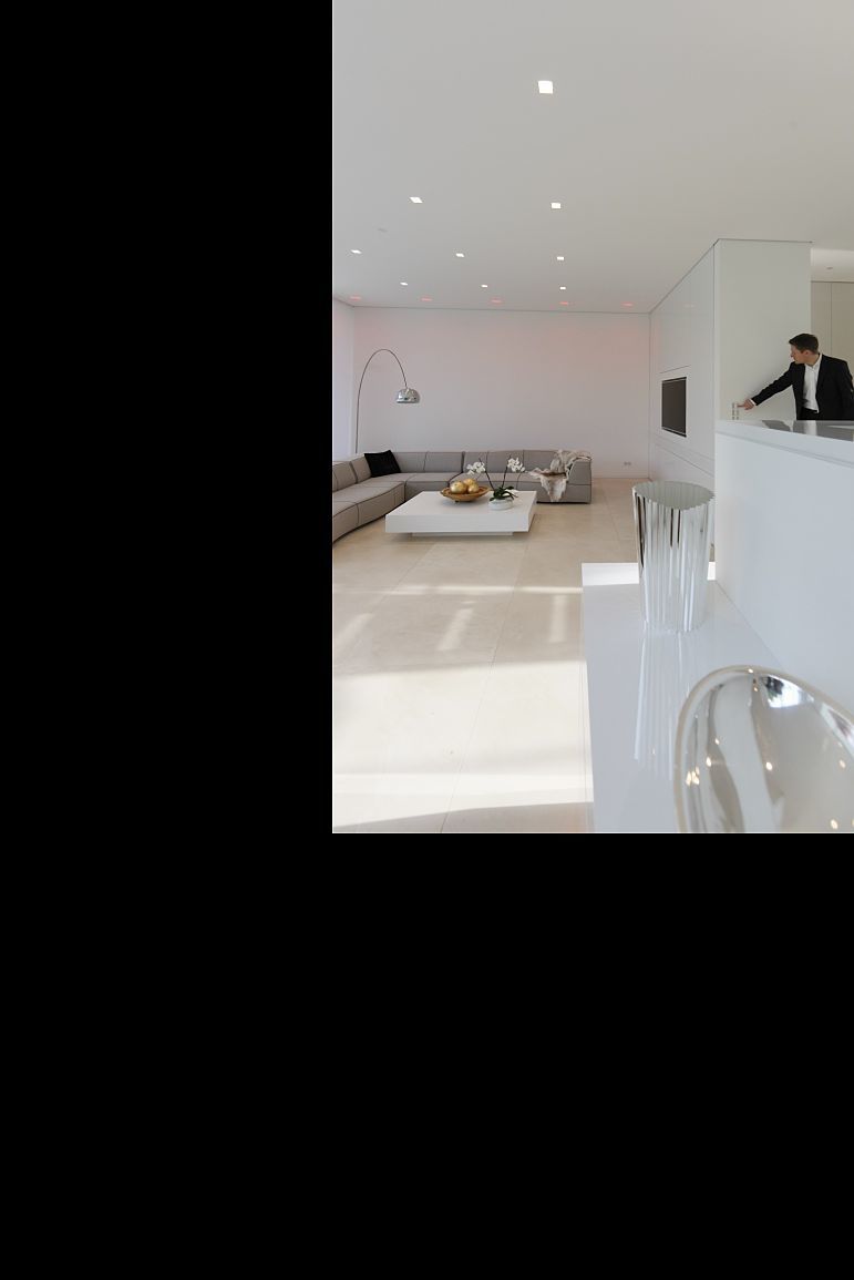 Villa Linari: Man adjusts Quintessence RGBW downlights for ambient lighting.
