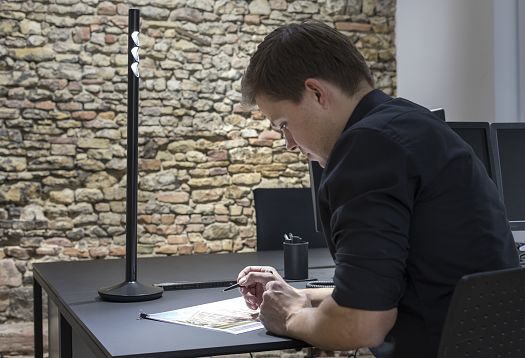 ERCO task light enhancing visual performance at a desk.