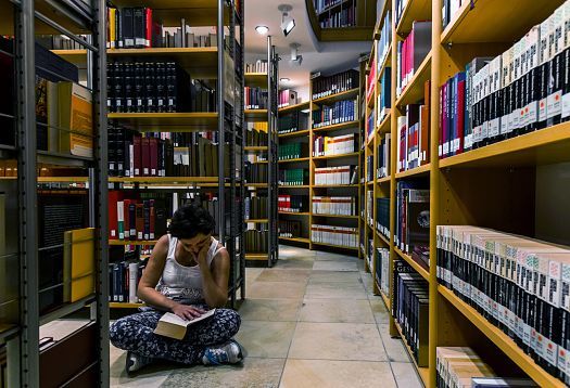 Reader in Vorarlberg State Library, illuminated by ERCO LED lighting tools.