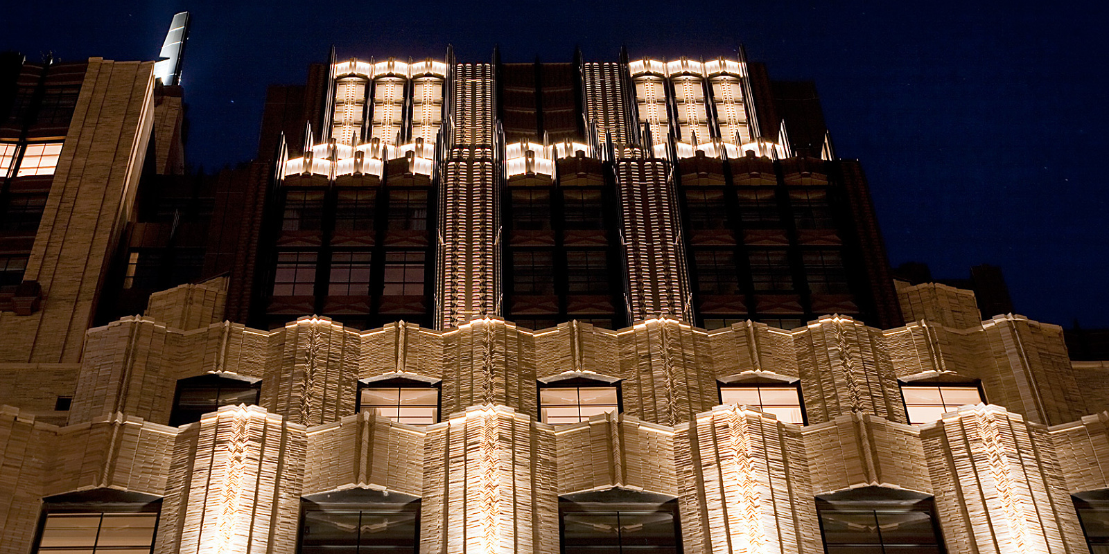 Close-up of the illuminated Walker Tower in New York, featuring ERCO lighting projectors.