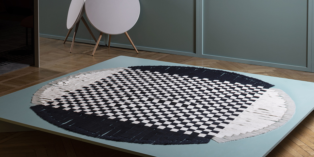 Handmade checkered rug displayed at the Wallpaper Handmade Exhibition.