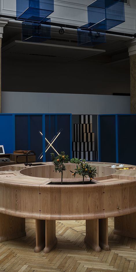 Handmade table with plants, illuminated by ERCO LED lighting at the Wallpaper Handmade Exhibition.