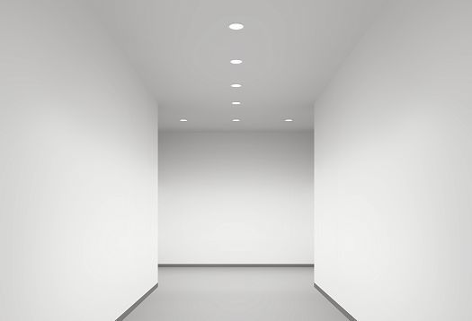 Hallway with uniform vertical lighting by ERCO wallwashers for orientation and brightness.