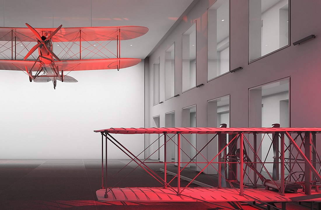 Rotes Licht akzentuiert Flugzeugmodelle, die räumliche Differenzierung und intensive Farbstimmung erzeugen.