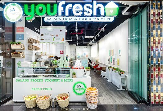 Youfresh bistro in Berlin, illuminated by ERCO Optec spotlights, showcasing fresh salads and frozen yogurt.