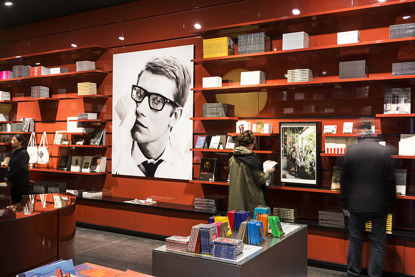 Yves Saint Laurent Museum shop featuring books and a portrait under ERCO LED lighting.