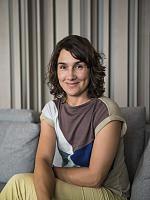 Portrait of a woman smiling in a room with ERCO lighting.